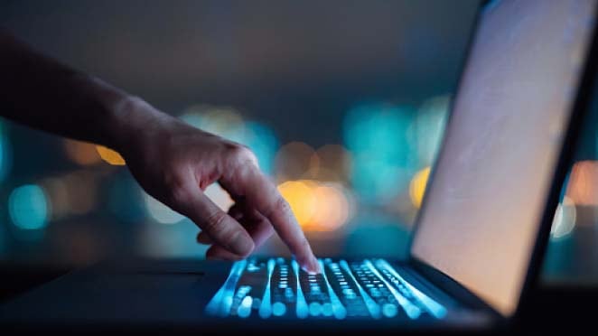 Person working on laptop to find Optical networking solutions