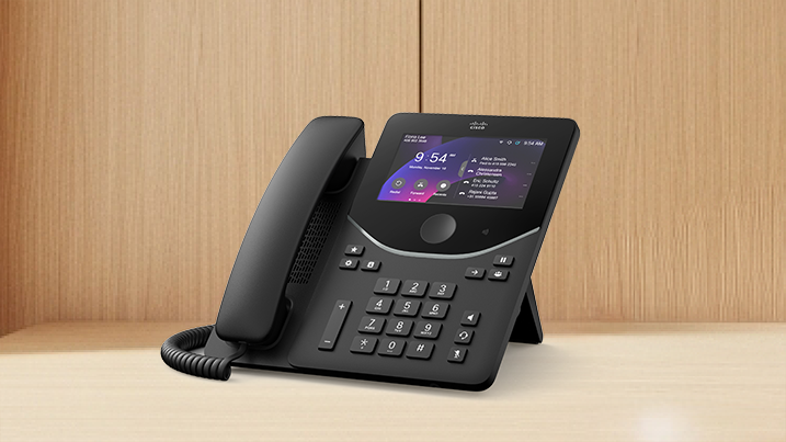Black Cisco IP desk phone with a touchscreen displaying 9:54 AM and a contact list including Alice Smith.