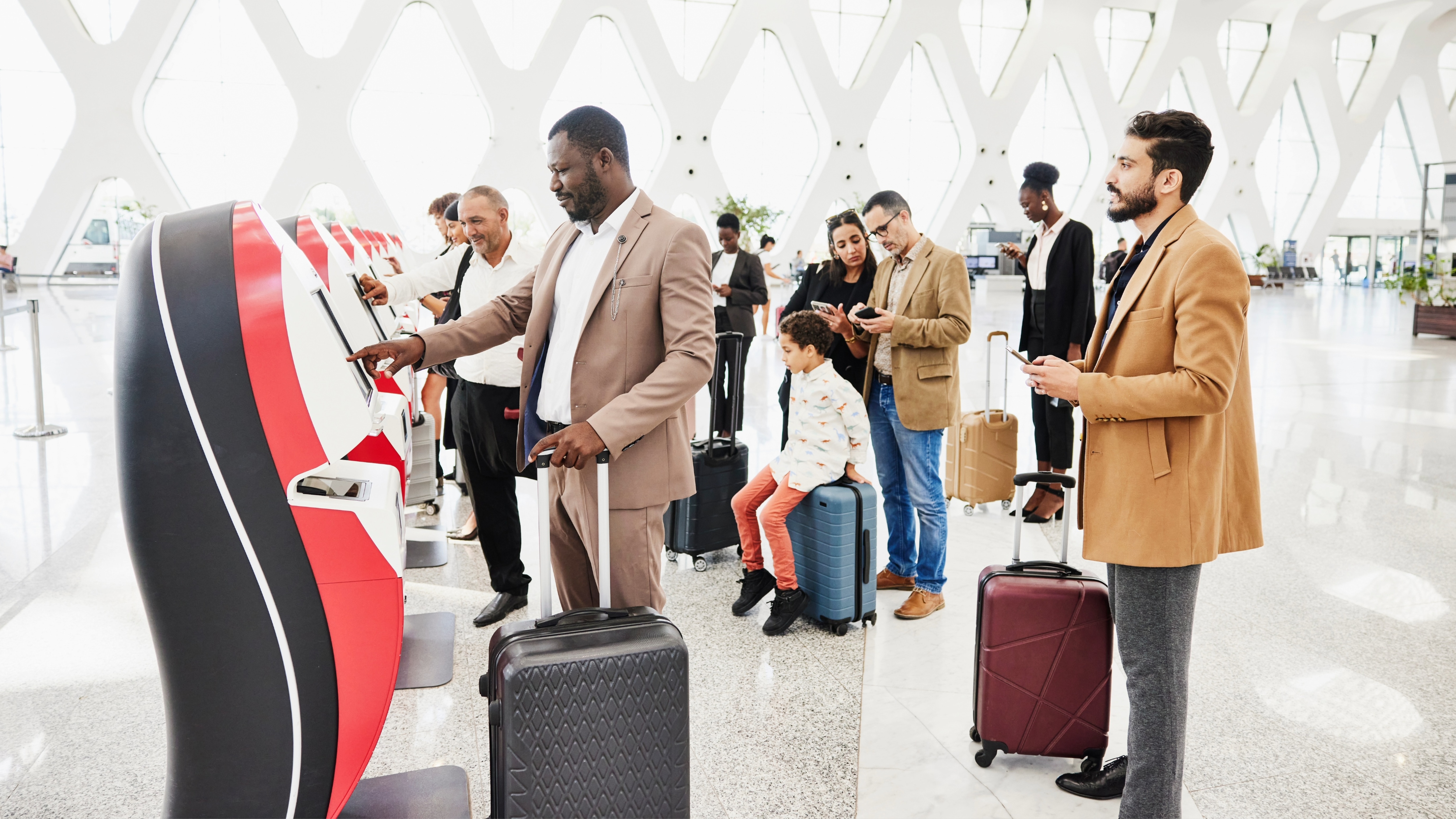 Travelers use airport kiosk
